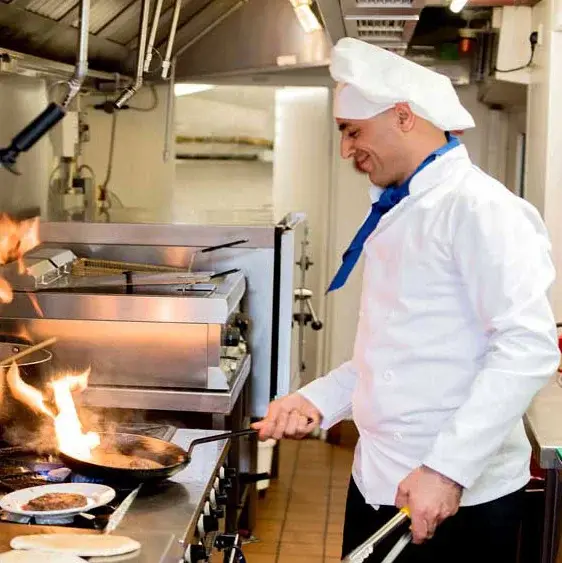 El Dorado Estates Chef Created Meals, chef frying a dish.