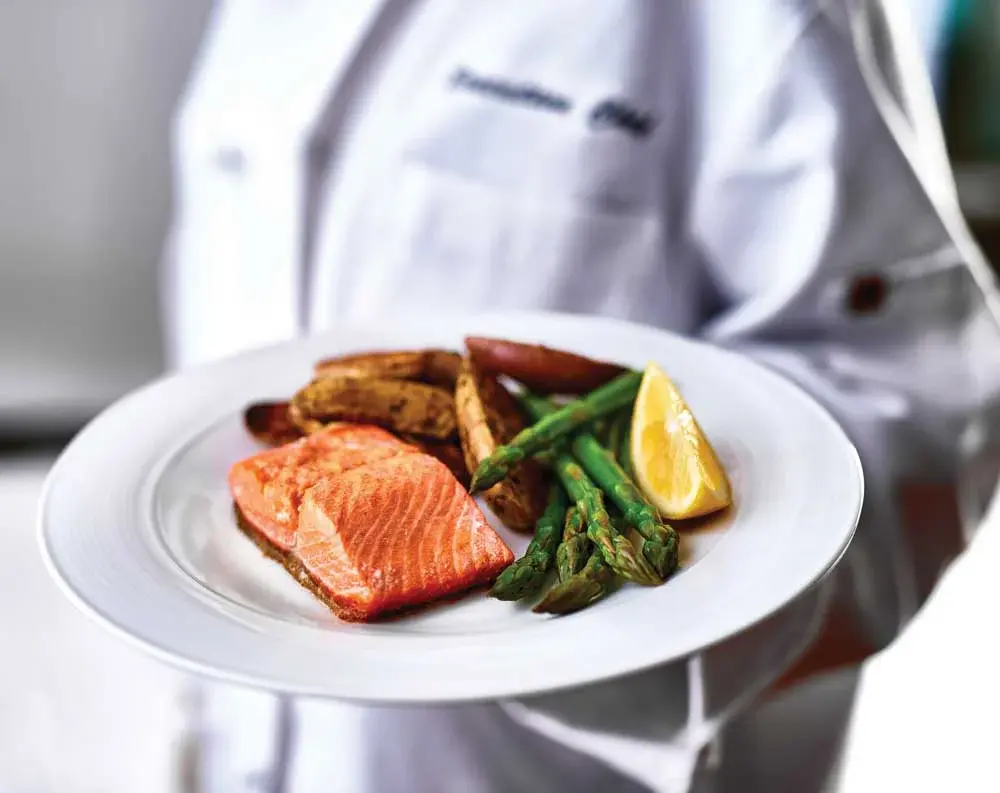 El Dorado Estates Chef Created Meals, chef delivering a finished dish.