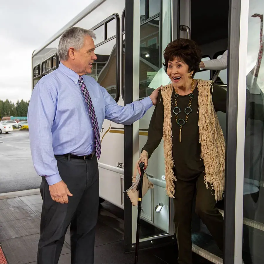 El Dorado Estates man helping lady off bus